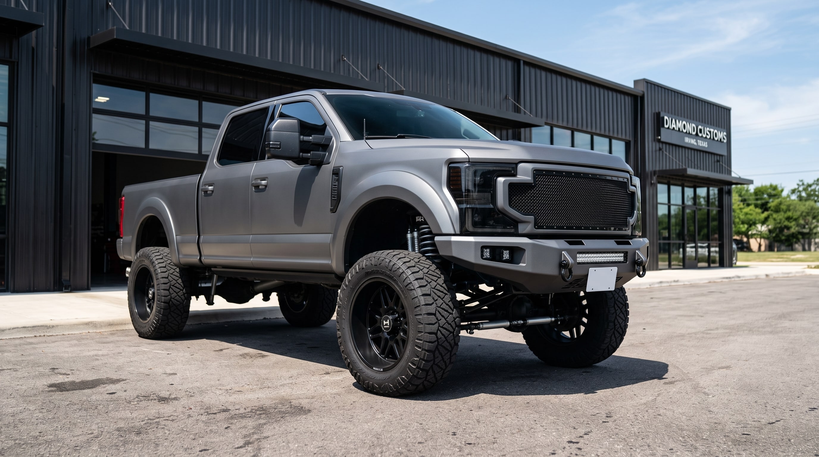 A lifted Ford F-250 comparing lift shocks vs stock performance — Metroplex Customs, Irving TX