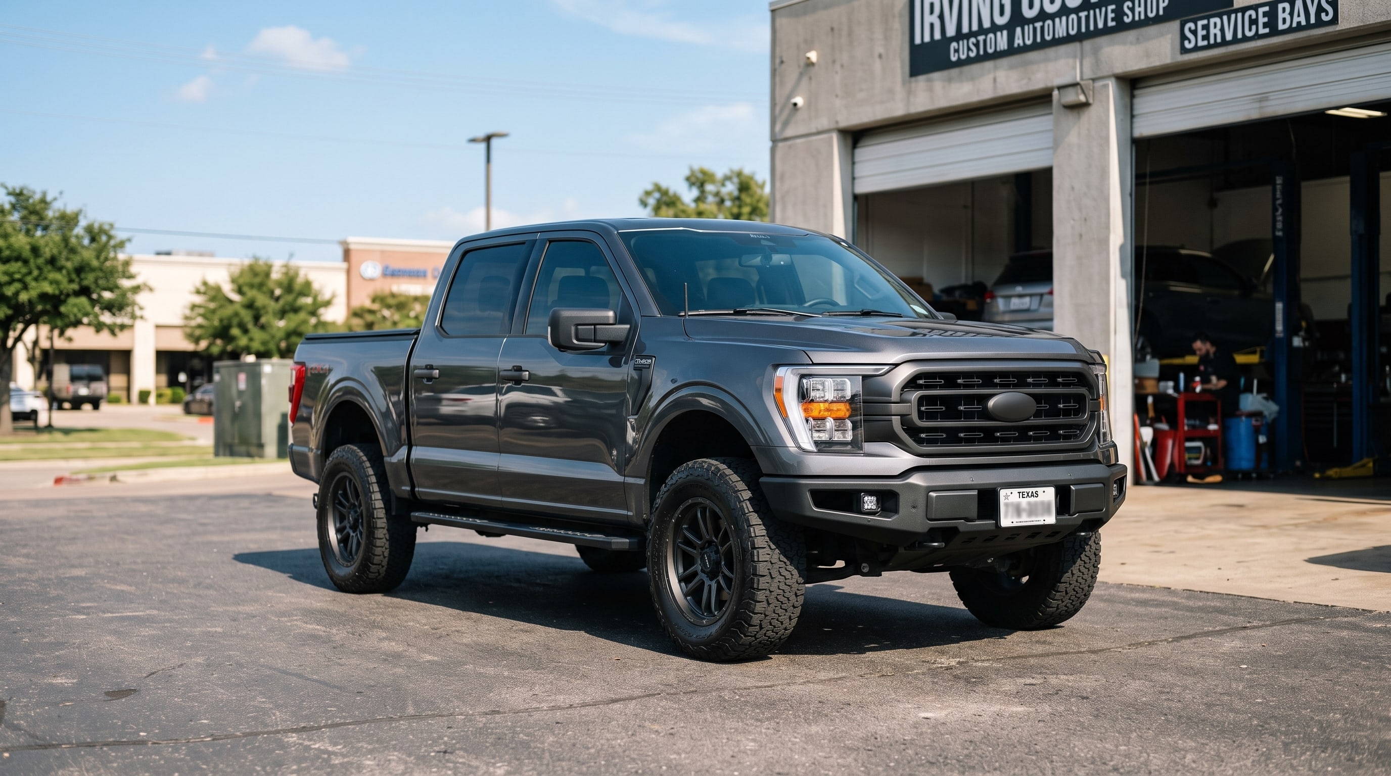 A leveled gray Ford F150 showing why you need to know what does a leveling kit do — Metroplex Customs, Irving TX