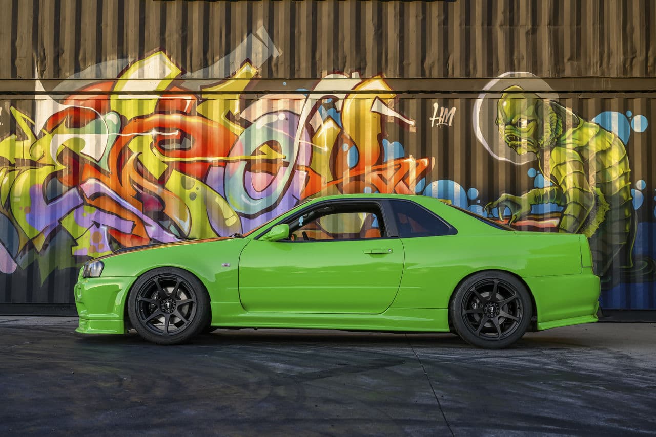Side profile of 1995 Nissan R34 Skyline with tuner wheels