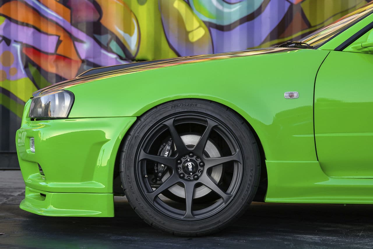 Rear view of 1995 Nissan R34 Skyline with tuner wheels