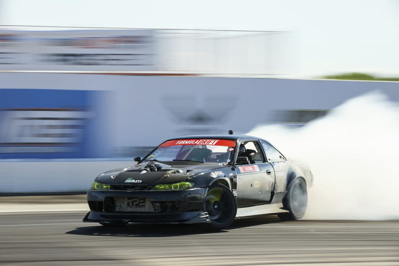 Rear view of 1998 Nissan 240SX with tuner wheels