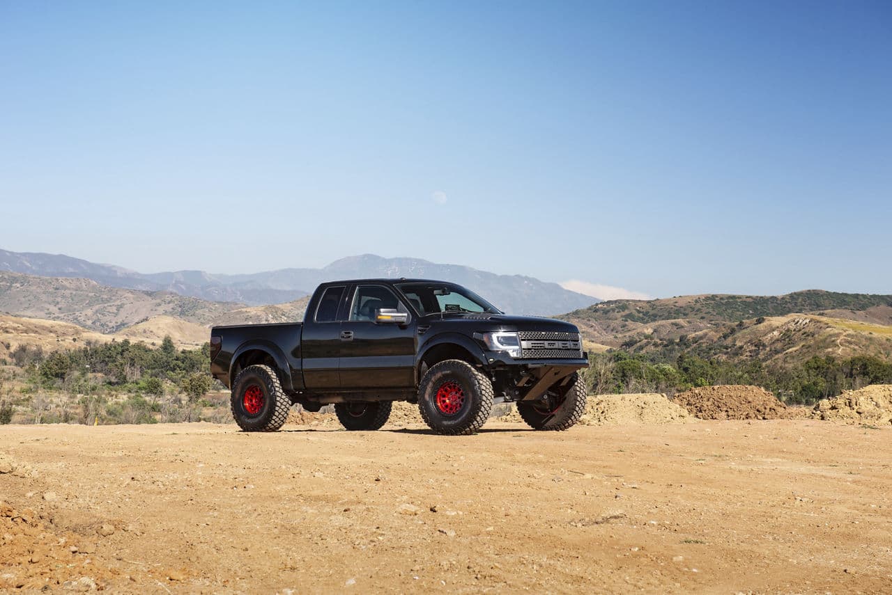 Front view of 2011 Ford F150 Raptor with vehicle wraps