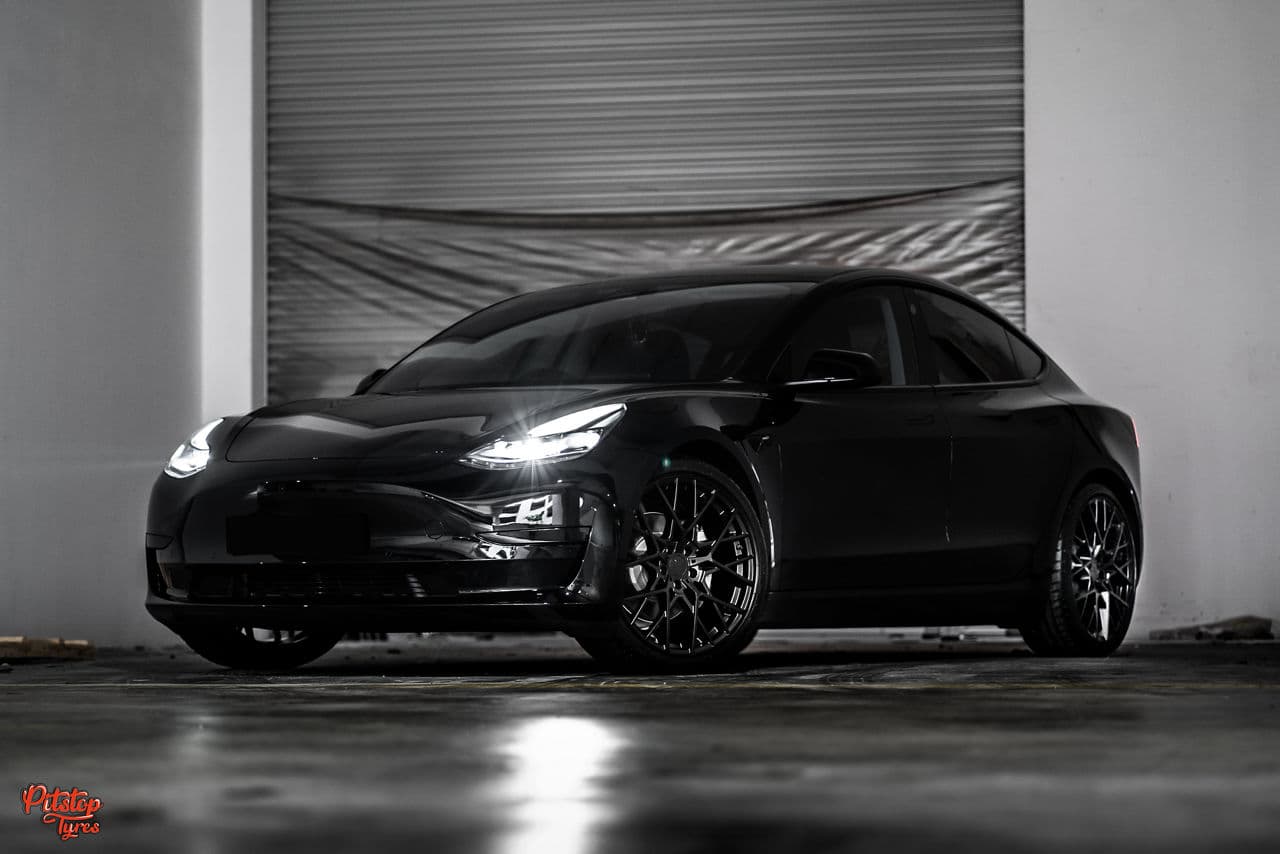 Rear view of 2020 Tesla Model 3 with wheels