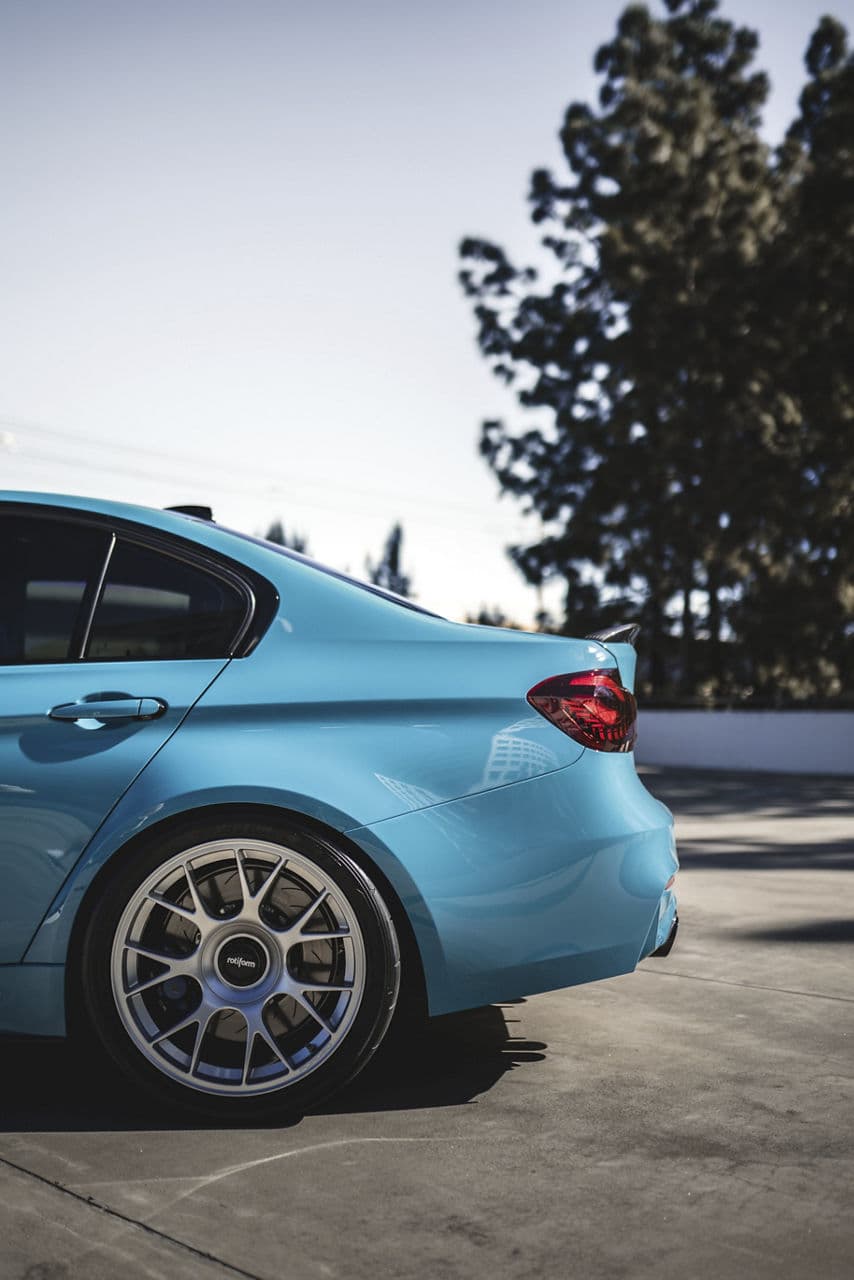 Rear view of 2022 BMW M3 with wheels