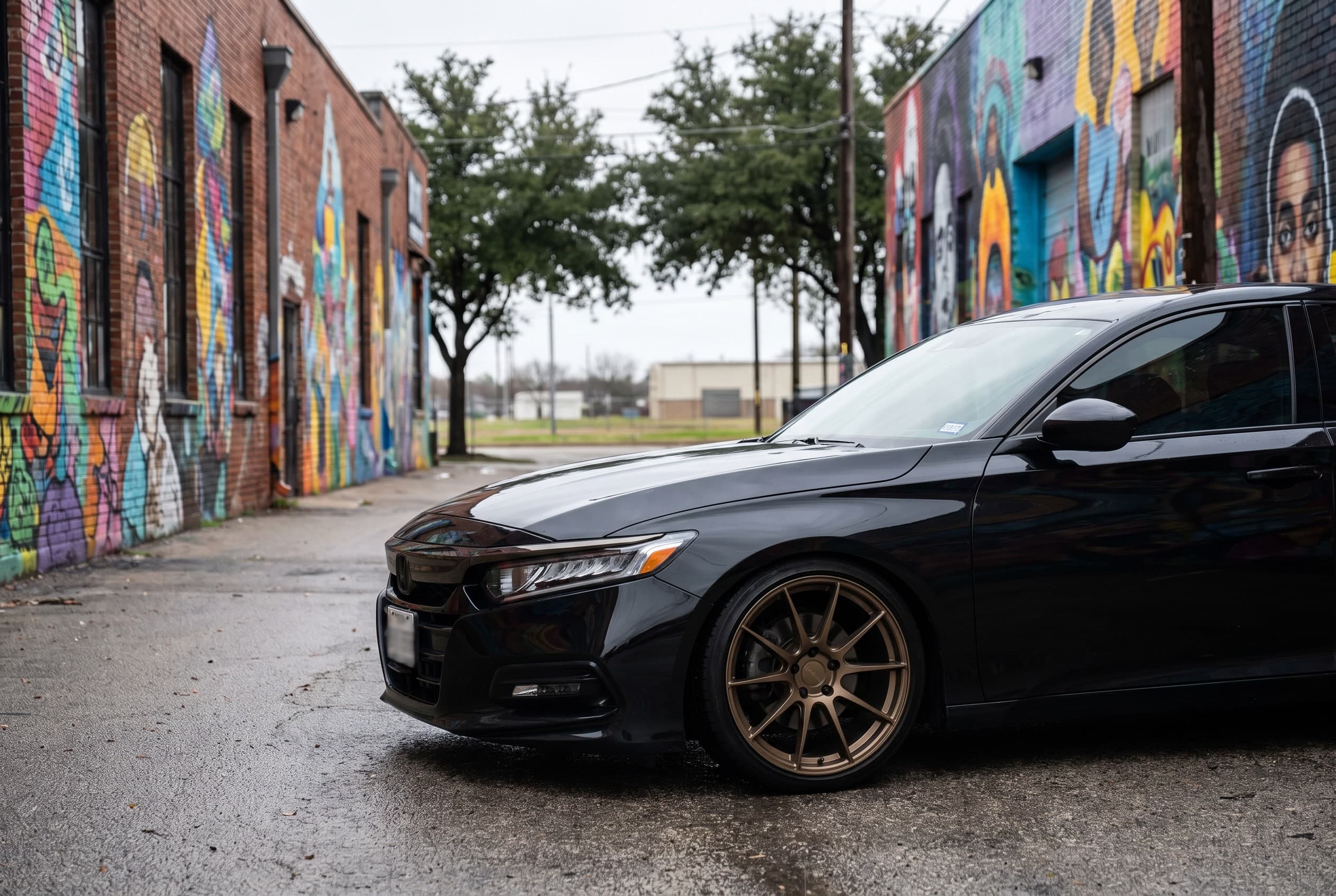 Lowered black Honda Accord on bronze wheels parked in a Bishop Arts District alley in Dallas