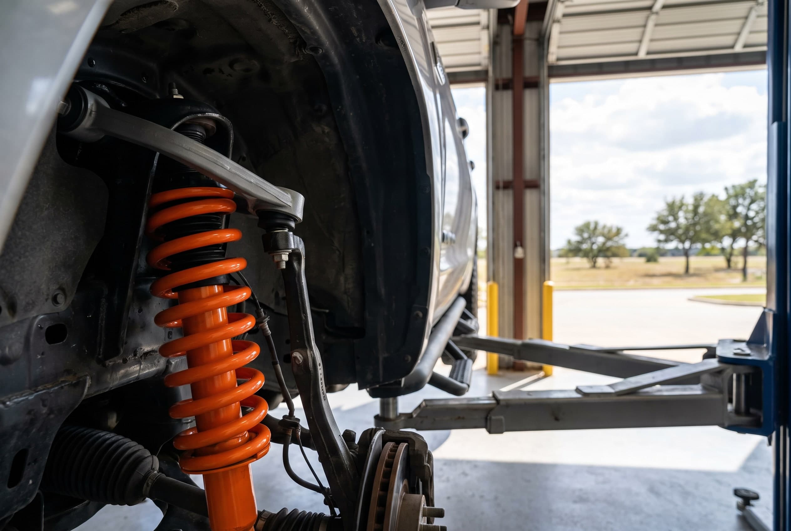New Fox 2.0 performance shock installed on the front suspension of a Toyota Tundra in a suspension shop serving Euless