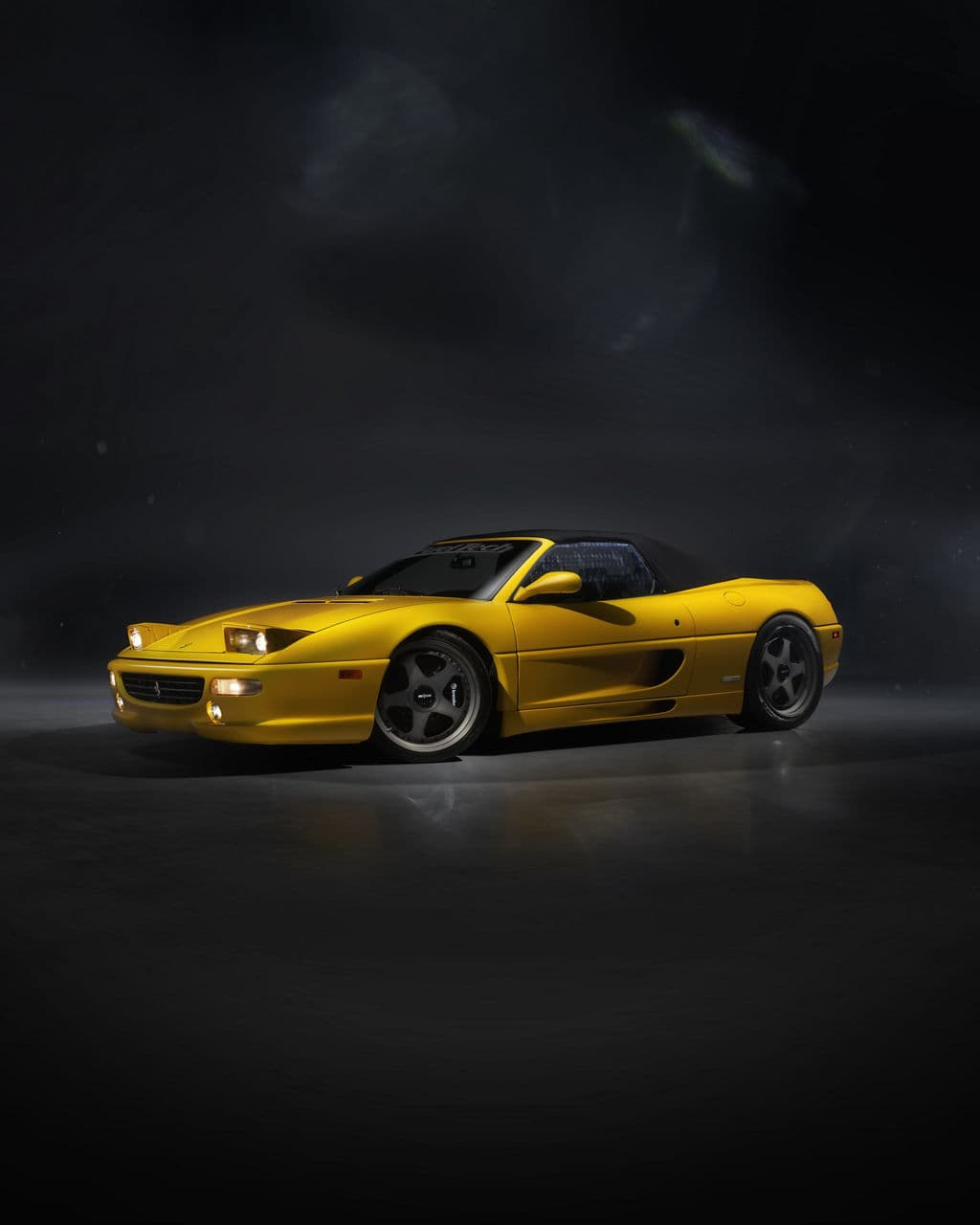 Side profile of 1995 Ferrari F355 Spider with wheels