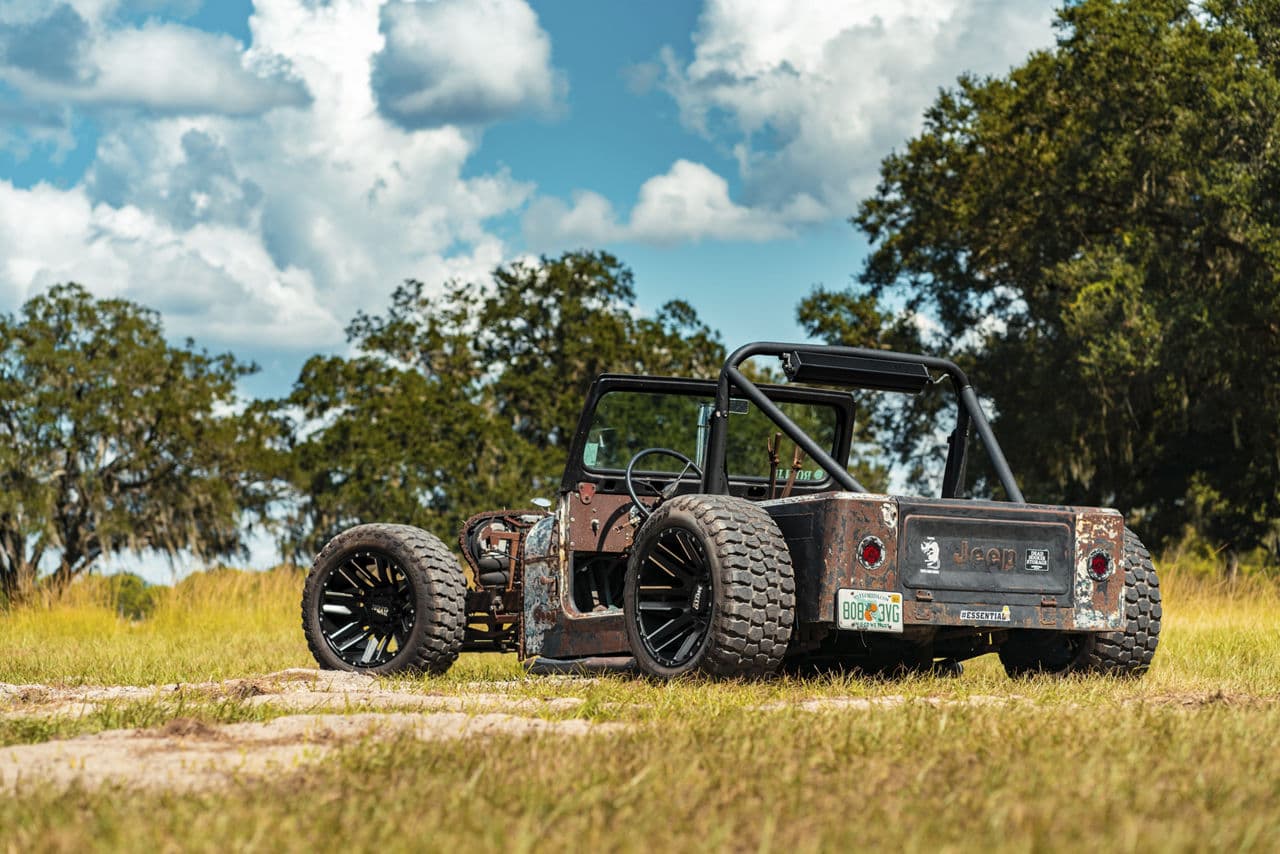 Rear view of 1995 Jeep Rat Rod with wheels