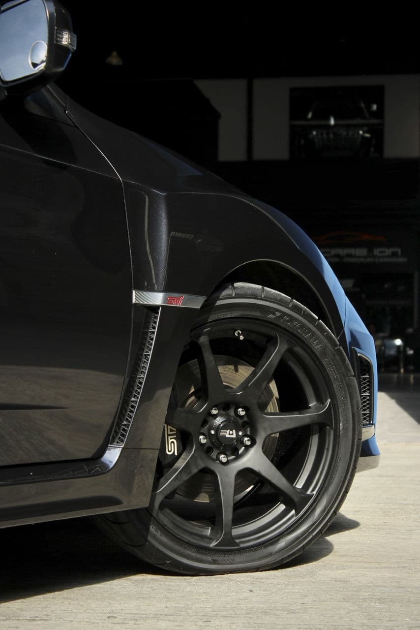 Side profile of 2013 Subaru WRX STI with wheels