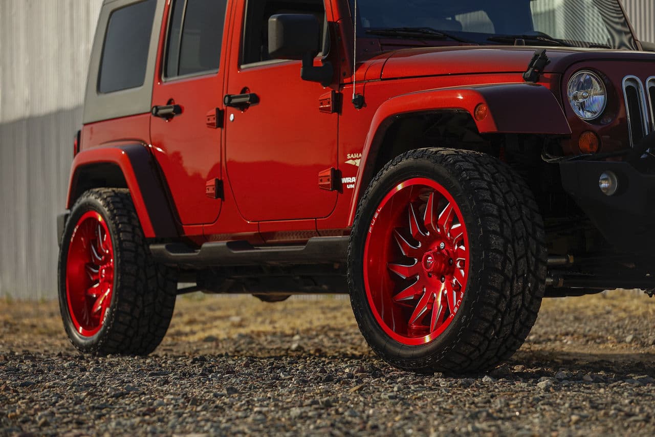 Side profile of 2014 Jeep Wrangler Unlimited with wheels