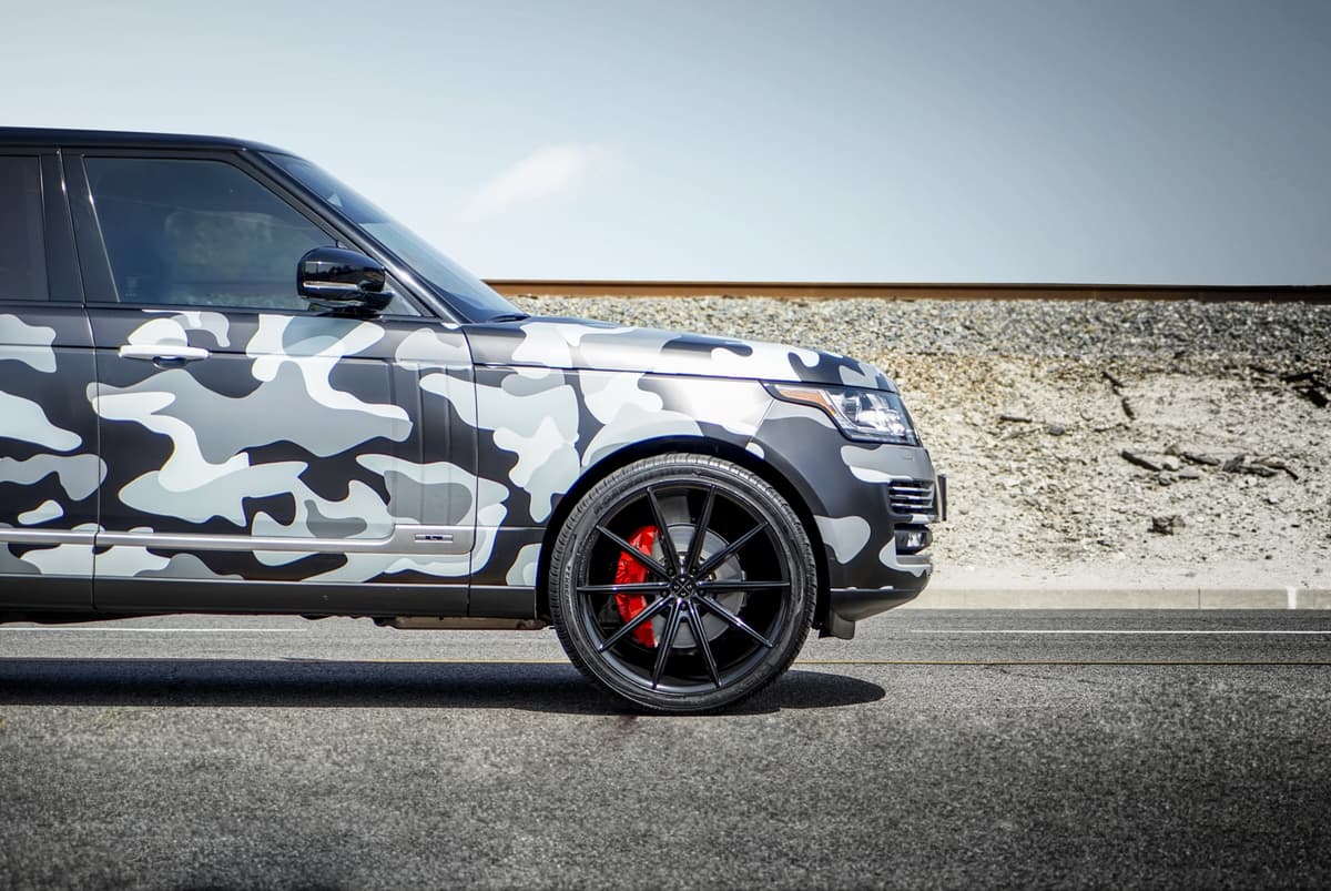 Range Rover — Range Rover in black/white/gray camo wrap (Metroplex Customs).
