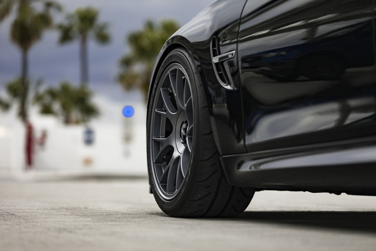 Rear view of 2019 BMW M3 with wheels