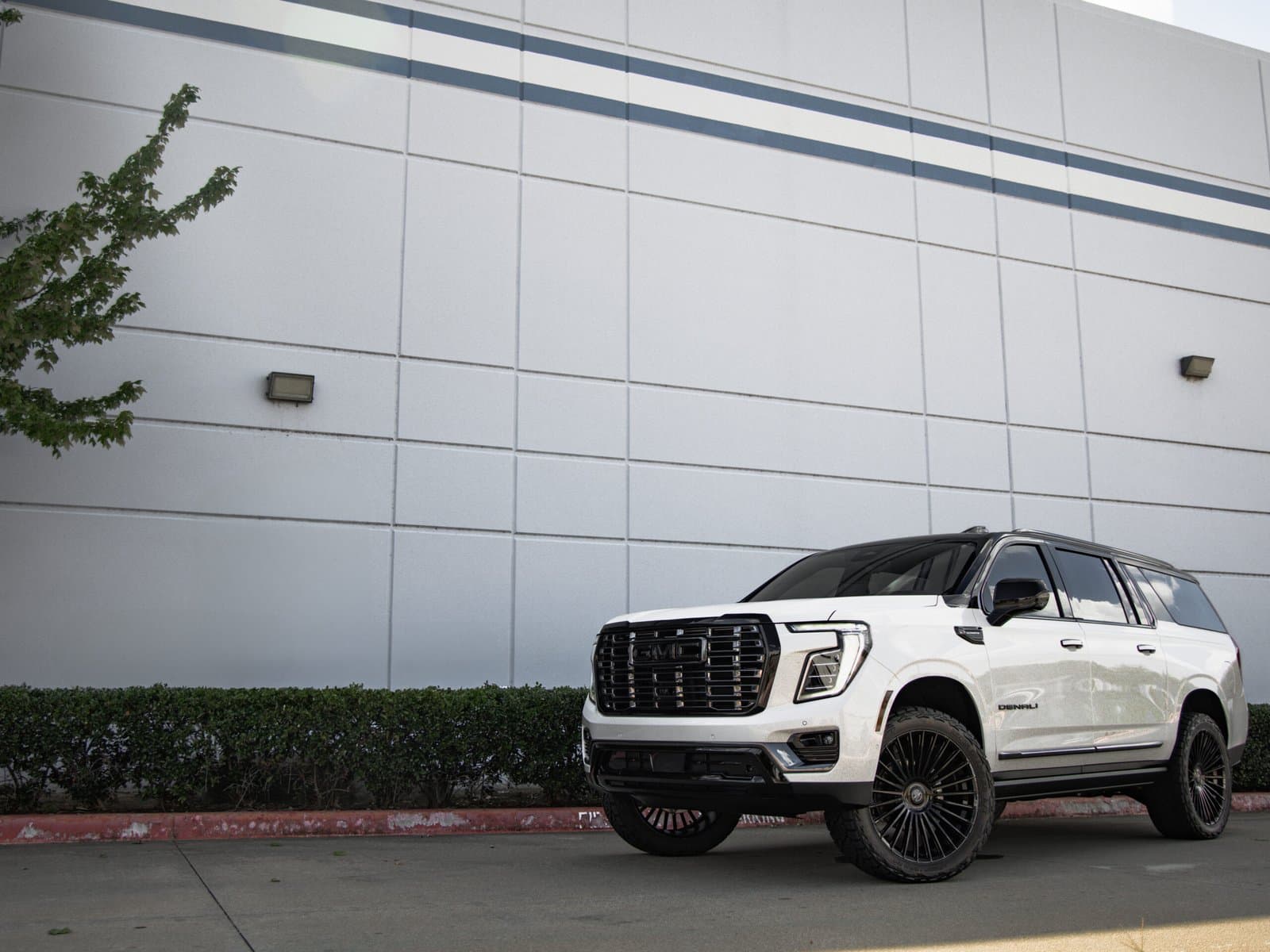 Custom white GMC Yukon Denali with black wheels and lifted suspension - Irving TX